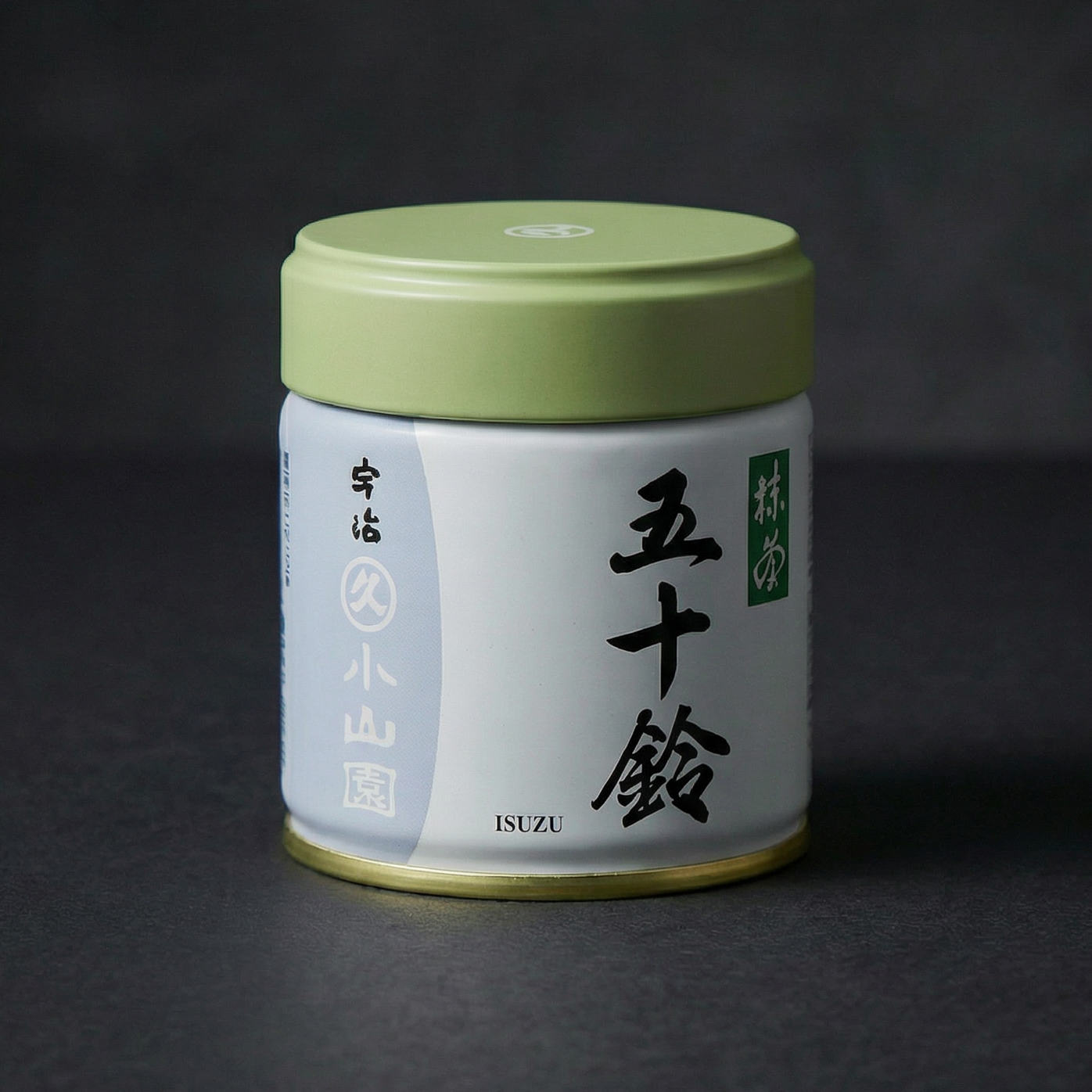 Marukyu Koyamaen Isuzu Japanese matcha powder in a 40 g metal tin in a black backdrop