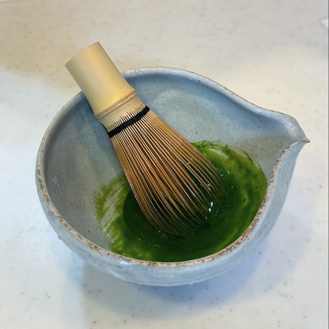 Single Cultivar Uji Matcha in a traditional japanese tea chawan or bowl. It includes a bamboo japanese chasen. Green matcha Koicha.